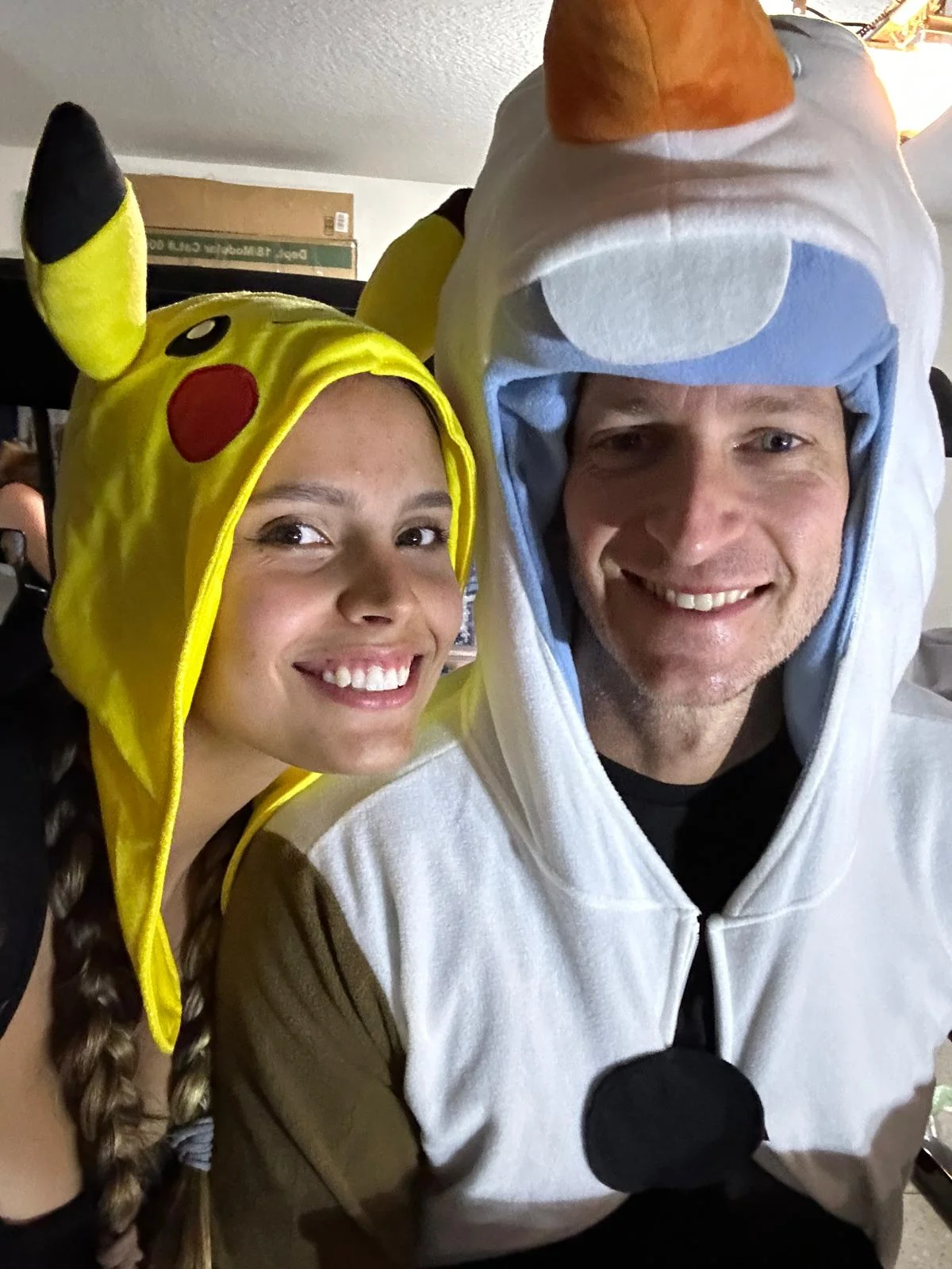 Rob and Veronica laughing together in matching costume hoods